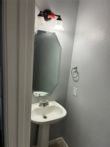 a bathroom with a sink and mirror
