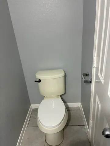 a white toilet sitting next to a sink