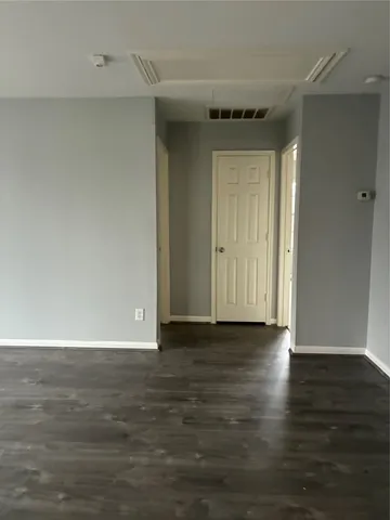a view of an empty room and wooden floor