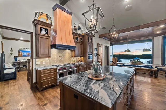 a kitchen with stainless steel appliances granite countertop a stove and refrigerator