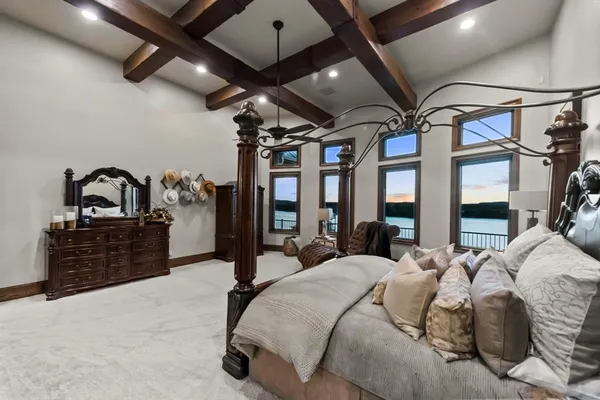 a bedroom with furniture and a large window