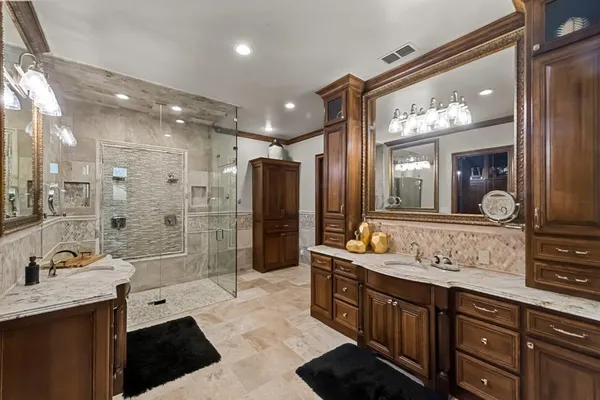 a bedroom with a bed and a mirror on the dresser