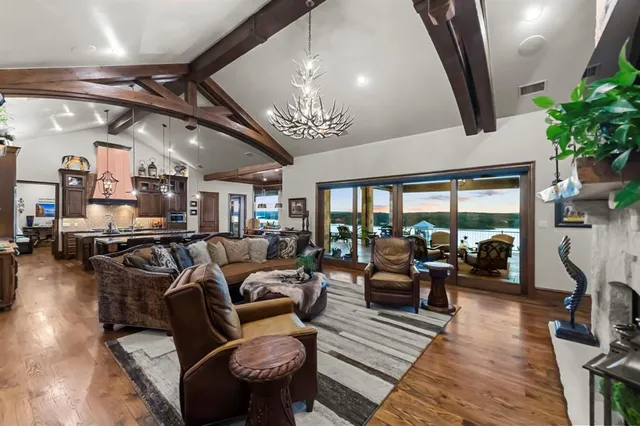 a living room with furniture and a chandelier