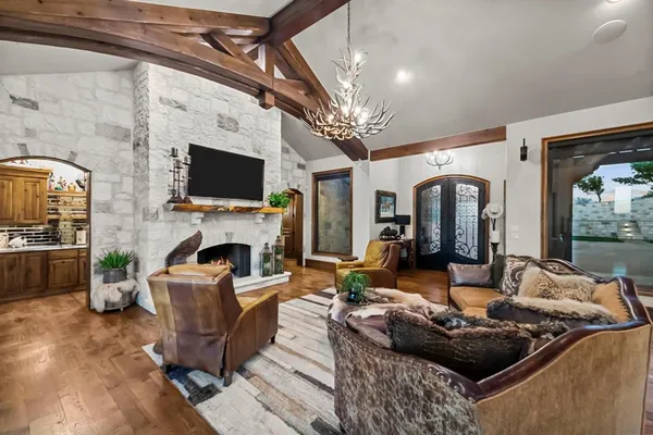 a living room with furniture a fireplace and a flat screen tv