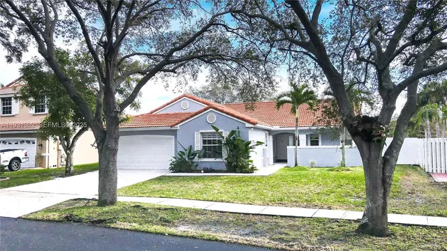 a front view of house with yard and green space