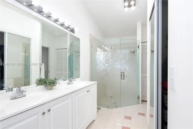 a bathroom with a shower sink and mirror