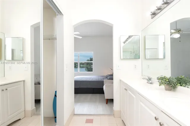 a bathroom with a bathtub sink and mirror