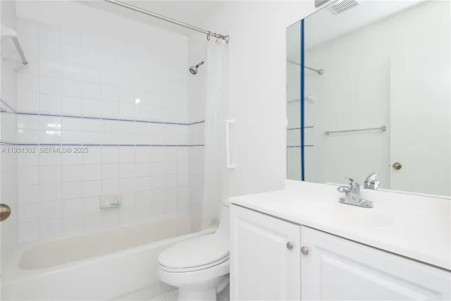 a bathroom with a sink mirror toilet and bathtub