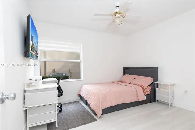 a bedroom with a bed couch and a window