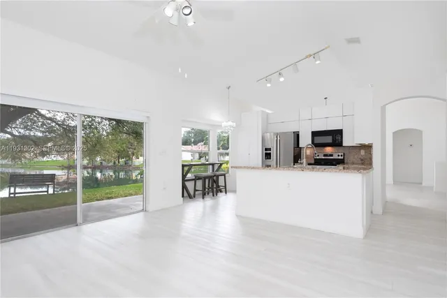 a view of kitchen with microwave and cabinets