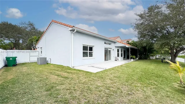 a view of a house with backyard porch and sitting area