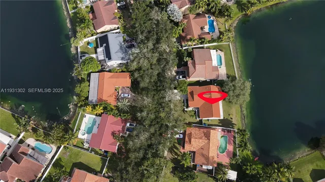 an aerial view of a house swimming pool and outdoor space