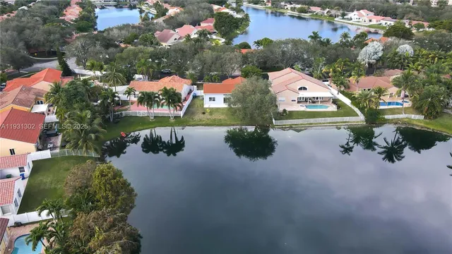 an aerial view of lake and houses with outdoor space
