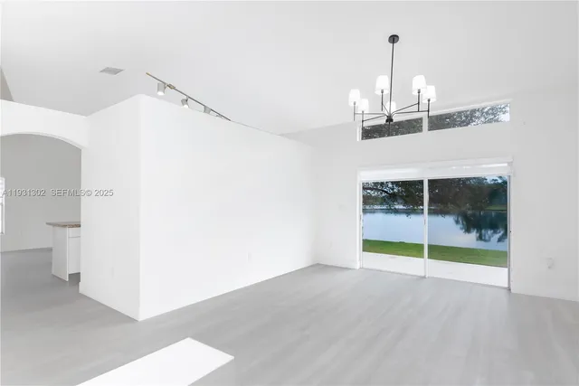 a view of a room with wooden floor and white walls