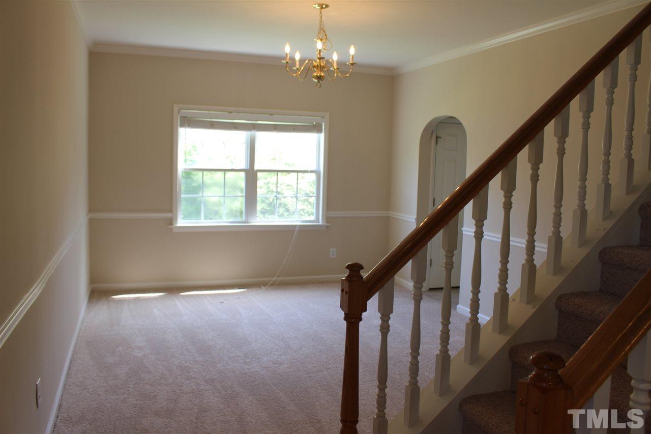1817 White Dogwood Road Apex, NC 27502 - Photo 2 of 13 a view of an entryway with wooden floor and stairs
