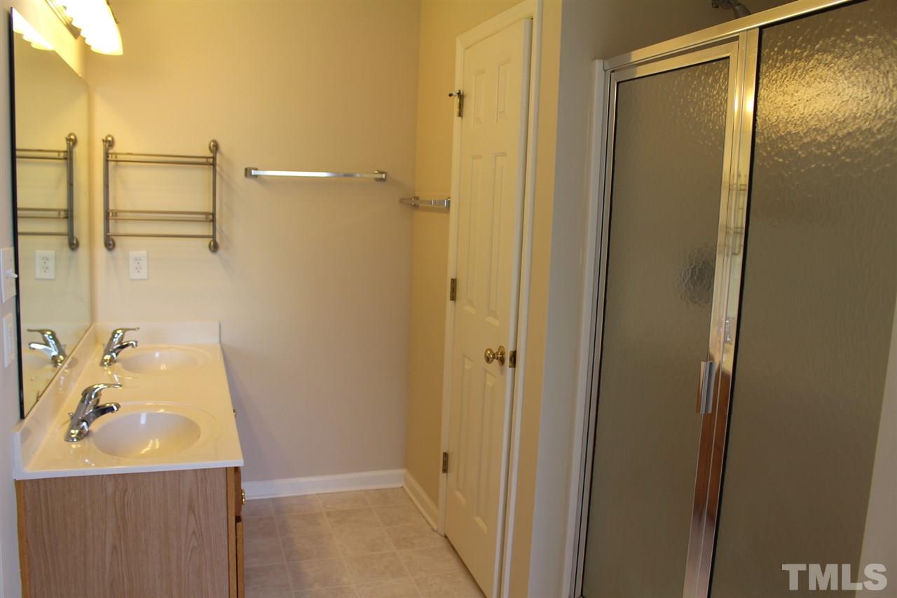 1817 White Dogwood Road Apex, NC 27502 - Photo 9 of 13 a bathroom with a shower and a sink