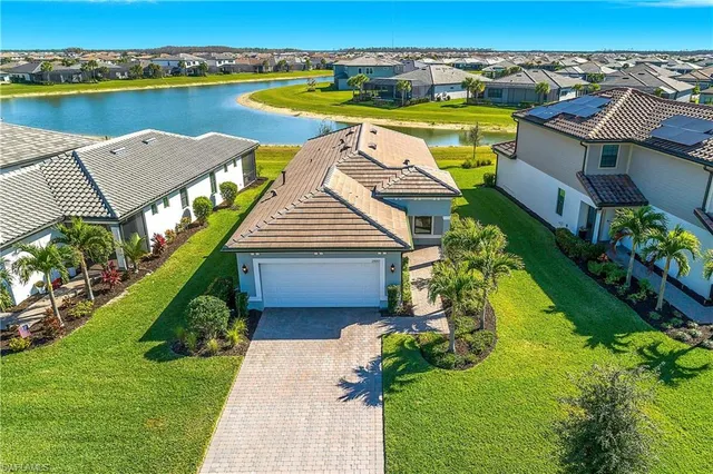 an aerial view of a house with outdoor space swimming pool and ocean view