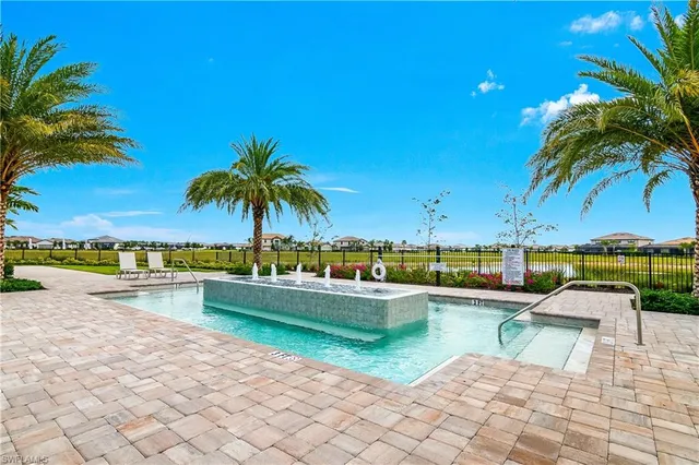 a view of swimming pool with outdoor seating and lake view
