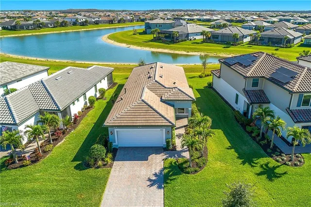 an aerial view of a house with a swimming pool yard and outdoor seating