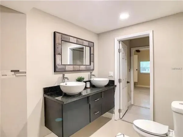a bathroom with a toilet sink and mirror