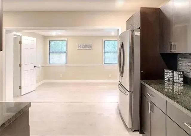 a bathroom with a granite countertop bathtub shower sink and mirror