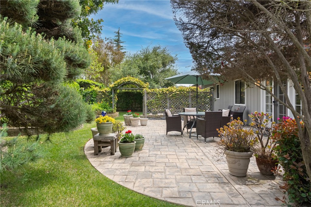 802 Pierce Drive Santa Maria, CA 93454 - Photo 30 of 42 a view of a patio with table and chairs potted plants and large tree