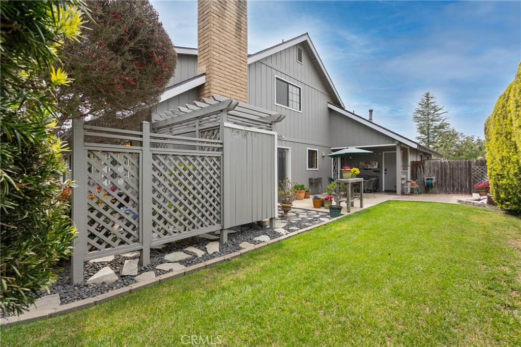802 Pierce Drive Santa Maria, CA 93454 - Photo 36 of 42 a view of a white house that has a small yard and large trees