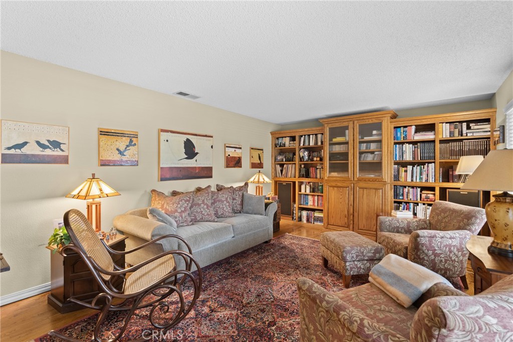 802 Pierce Drive Santa Maria, CA 93454 - Photo 4 of 42 a living room with furniture and a bookshelf with wooden floor