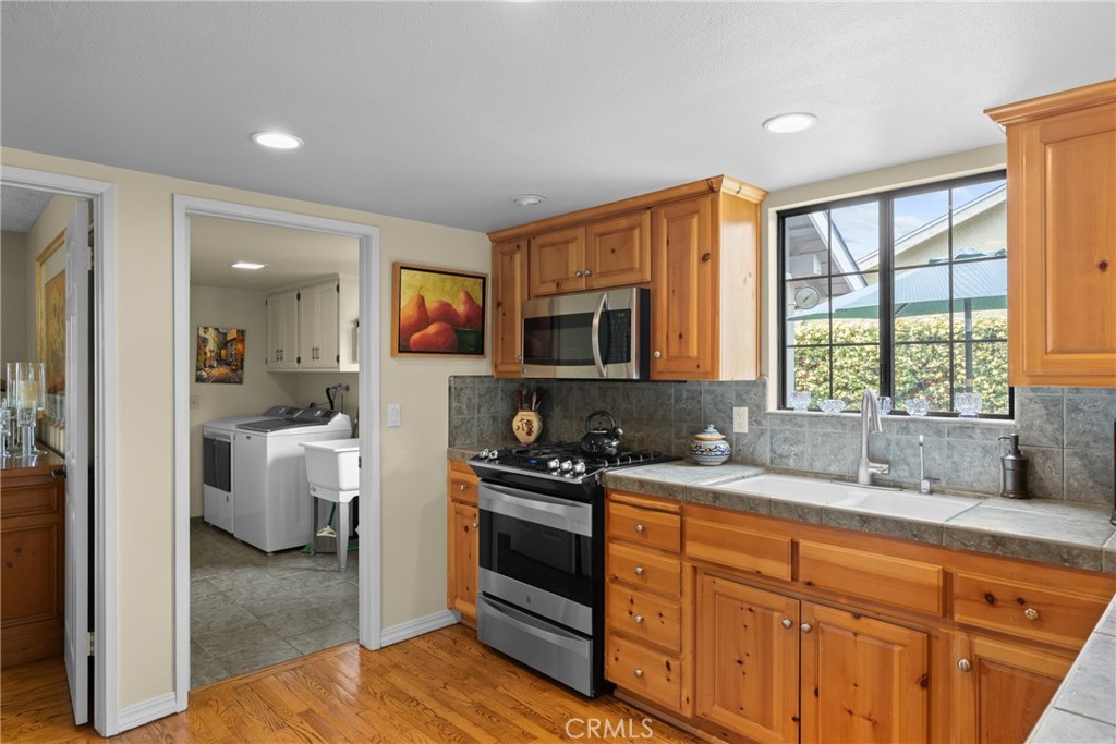 802 Pierce Drive Santa Maria, CA 93454 - Photo 9 of 42 a kitchen with a sink stove and cabinets