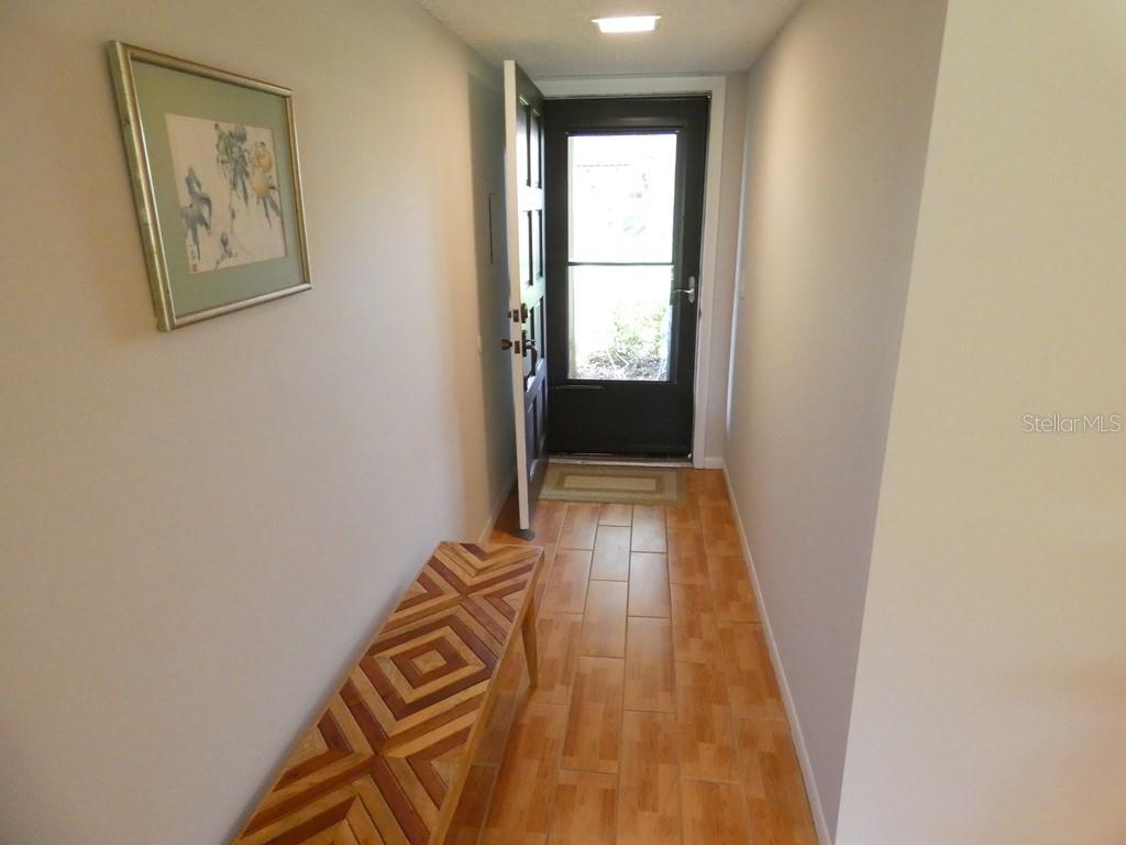 1701 Pinehurst Road, Unit 9G Dunedin, FL 34698 - Photo 11 of 22 a view of a room with wooden floor