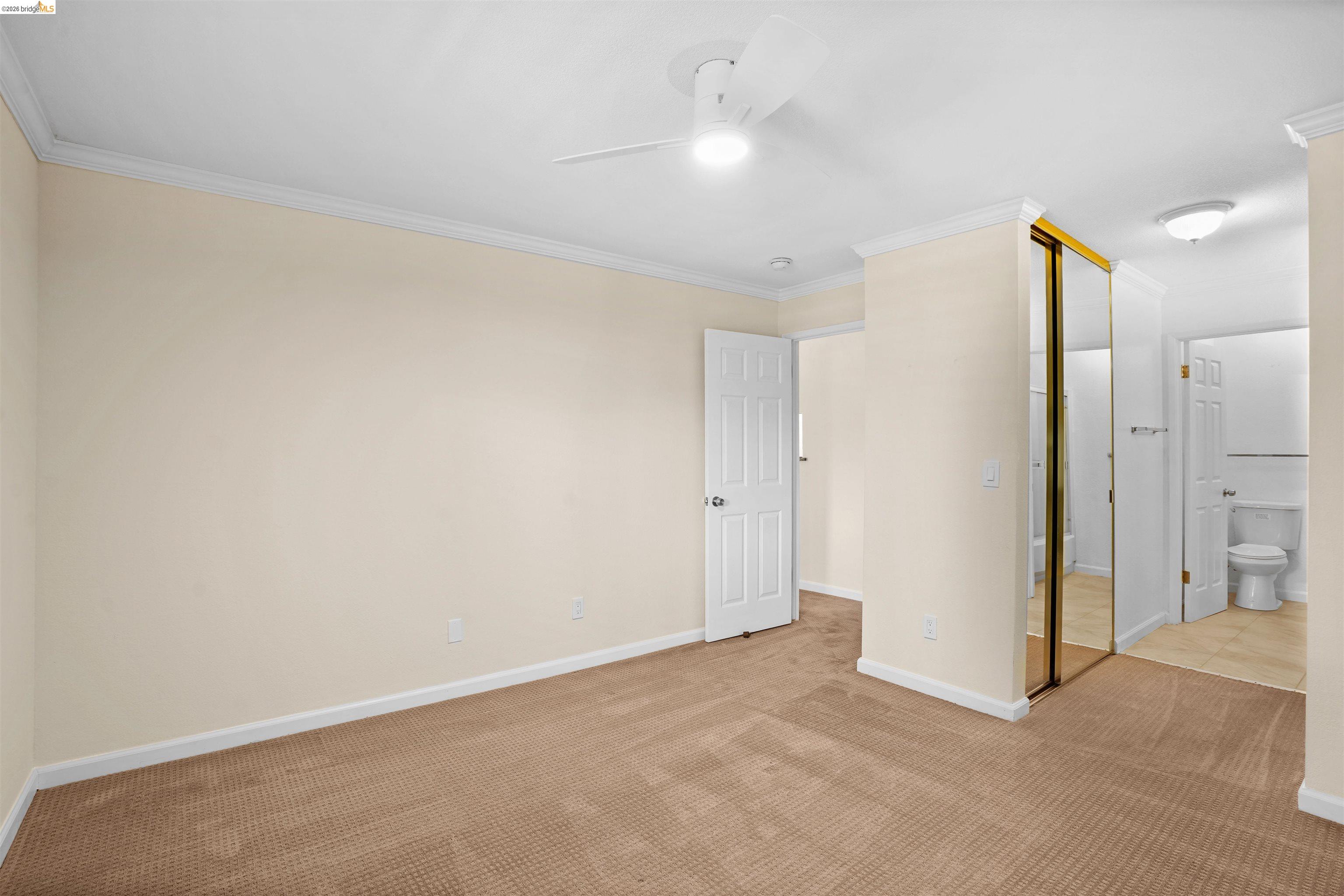 1505 Kirker Pass Road, Unit 214 Concord, CA 94521 - Photo 33 of 55 Carpeted bedroom with crown molding, a ceiling fan with integrated lighting, and a mirrored closet