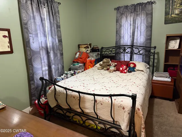 a bedroom with furniture and dresser