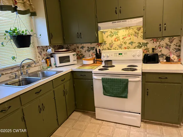 a kitchen with a sink cabinets and appliances
