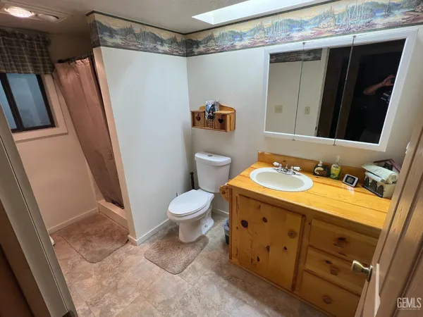 a bedroom with a bed and a mirror