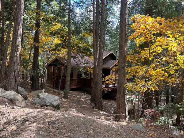 a view of a wooden house with a tree