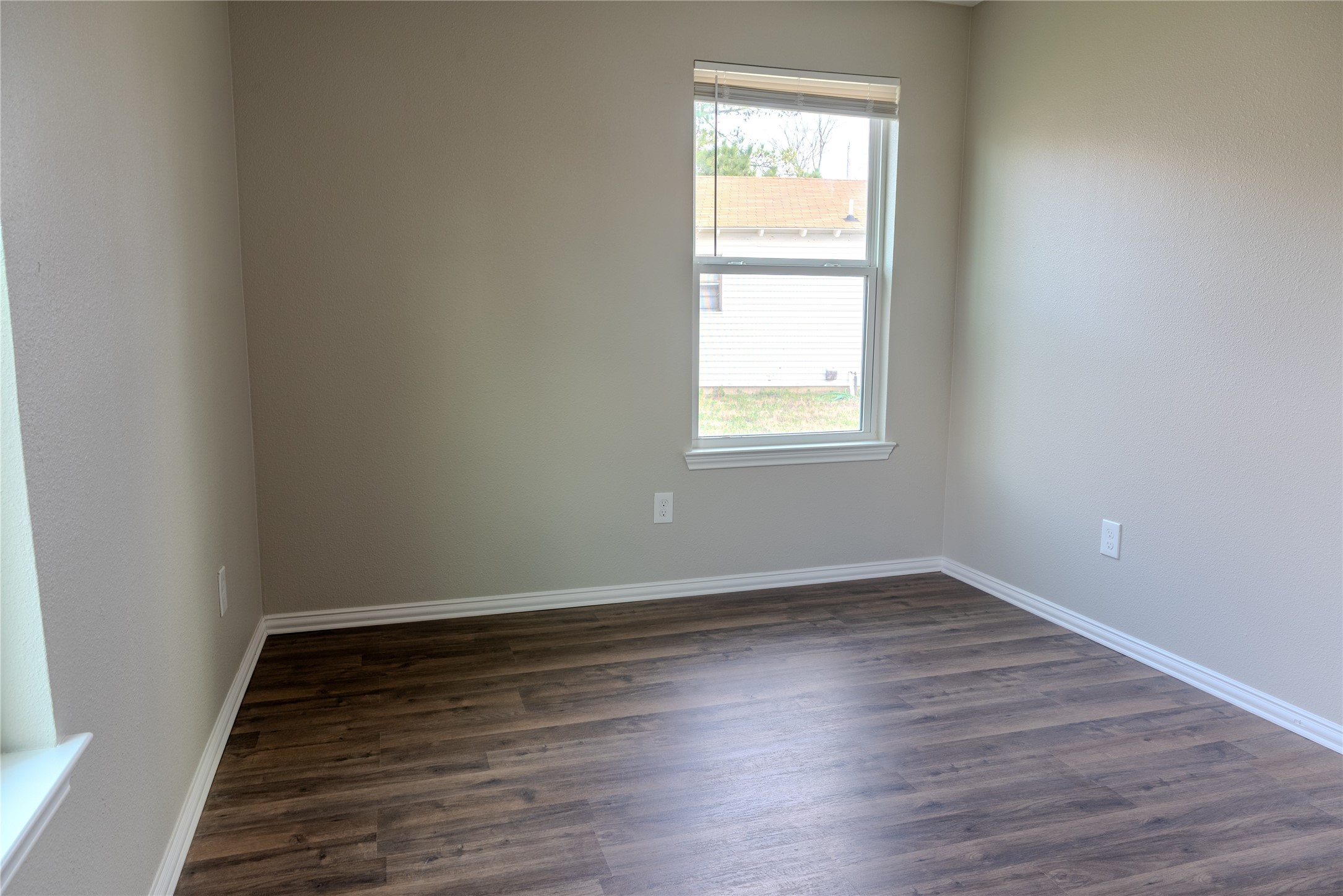 729 Planters Street Emory, TX 75440 - Photo 18 of 22 an empty room with wooden floor and windows