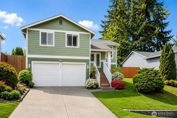 a front view of house with yard and green space