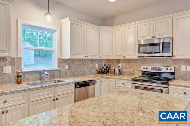 2508 Buck Island Road Charlottesville, VA 22902 - Photo 5 of 23 a kitchen with granite countertop a stove sink and cabinets