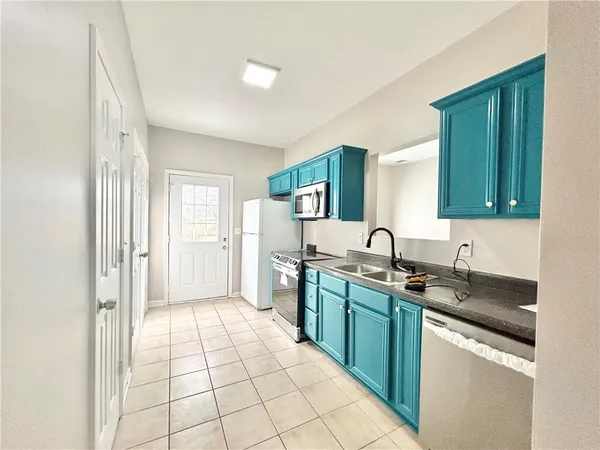 a kitchen with a sink a stove and cabinets