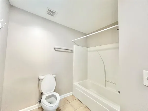 a bathroom with a toilet and a bathtub