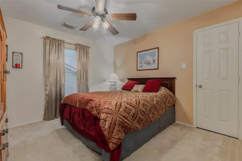 a bed sitting in a bedroom next to a window