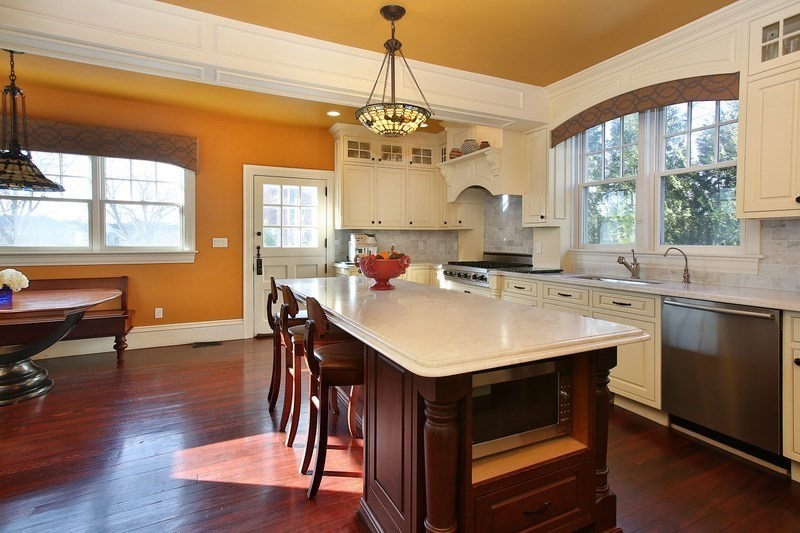 460 A Heath Street Brookline, MA 02467 - Photo 4 of 22 a kitchen with a sink a stove a dining table and chairs