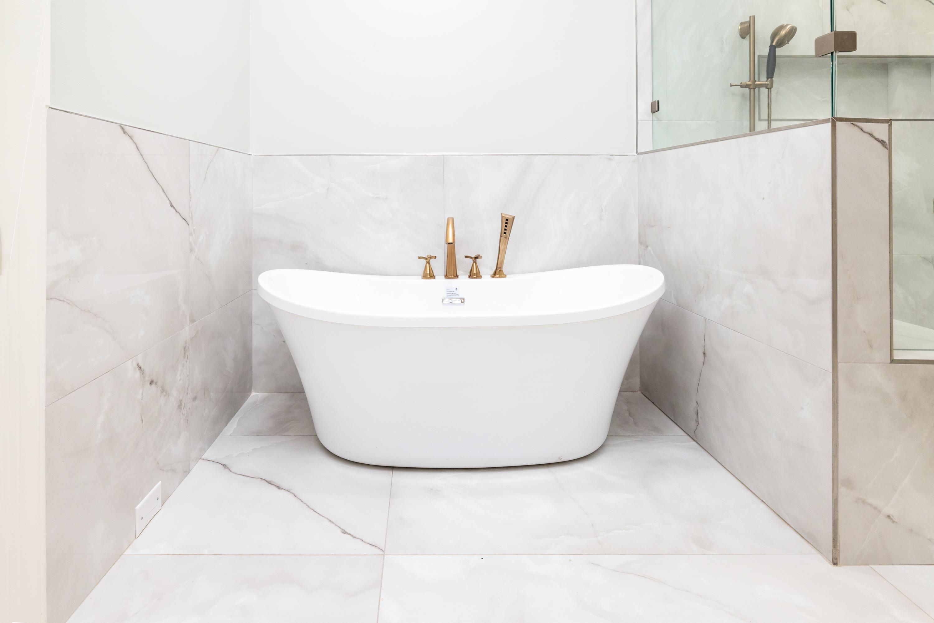 a white bath tub sitting in a bathroom
