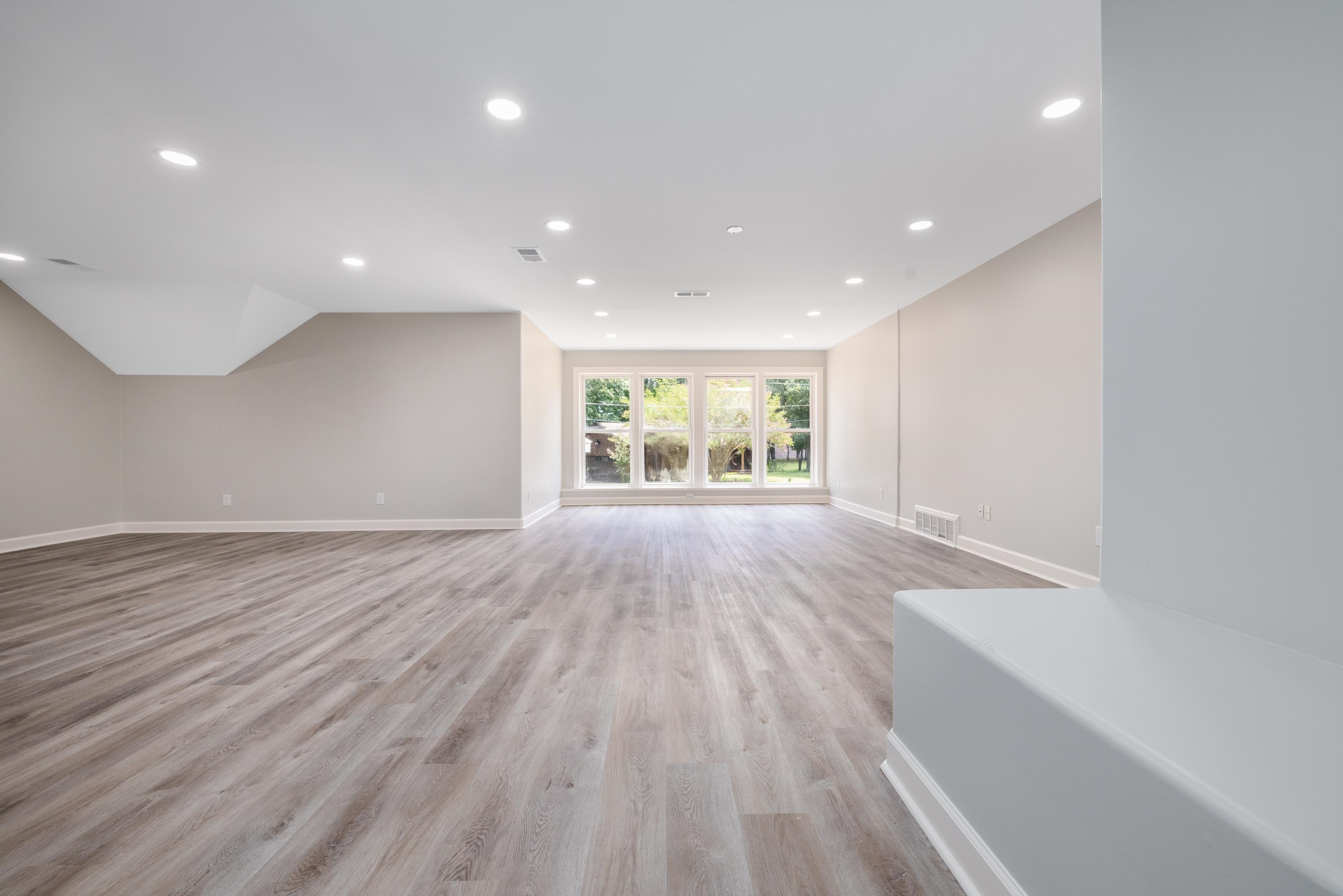 4175 Cedar Point Road Lakeland, TN 38002 - Photo 5 of 37 an empty room with wooden floor and windows