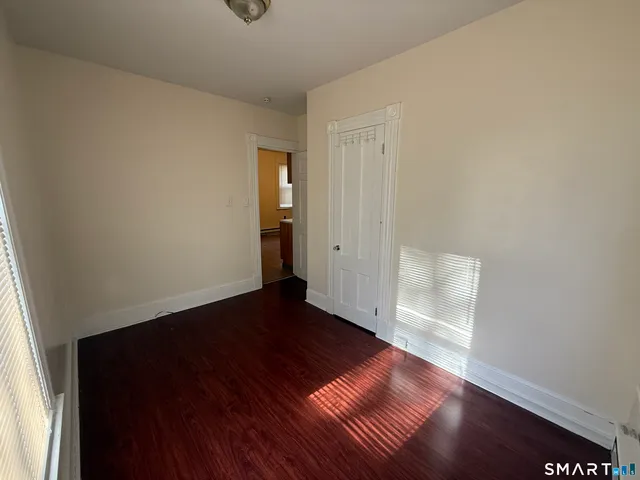 an empty room with wooden floor