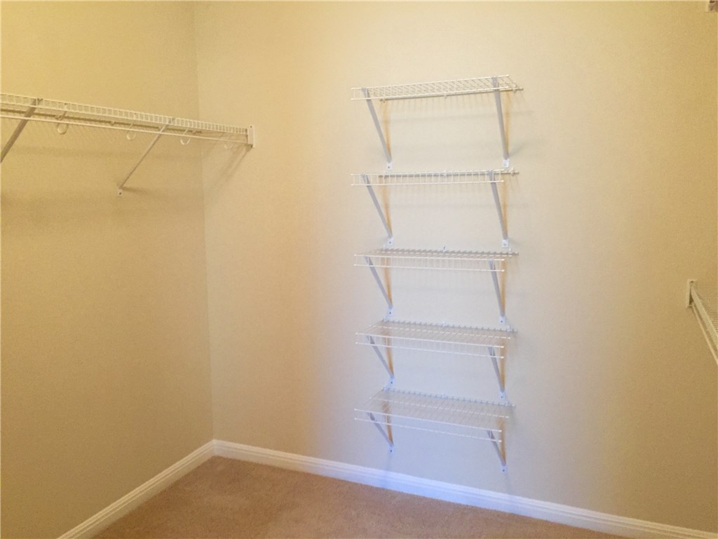 3451 Mayfield Ranch Boulevard, Unit 703 Round Rock, TX 78681 - Photo 14 of 23 a view of an empty walk in closet