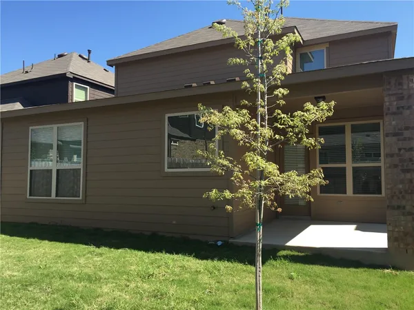 a flower garden is sitting in front of a house