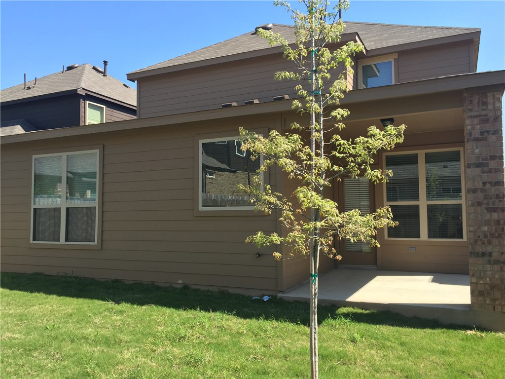 3451 Mayfield Ranch Boulevard, Unit 703 Round Rock, TX 78681 - Photo 23 of 23 a flower garden is sitting in front of a house