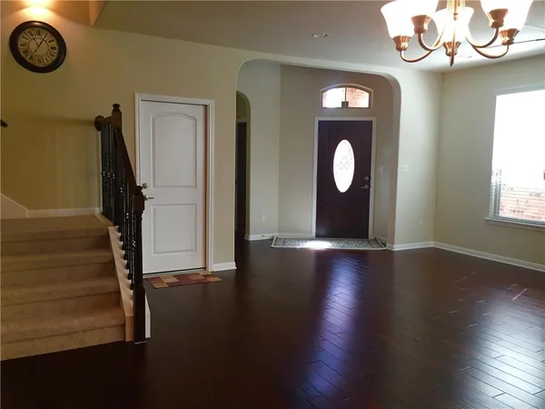 a view of an entryway with wooden floor