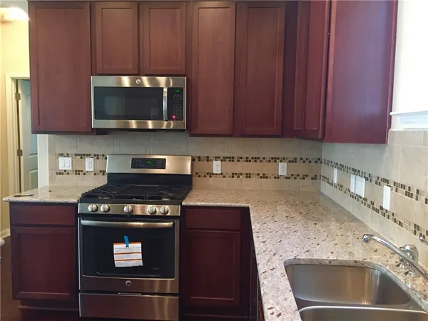 a kitchen with a stove and a microwave